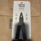 Swiss Tech Praktisch Steel 17-IN-1 Folding Multi Tool With Leather Sheath. Fixed Price $55.00.